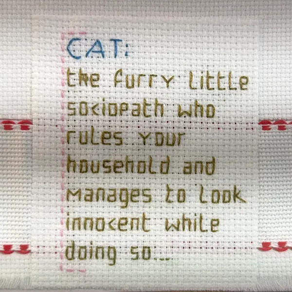 Closeup of text on cat embroidery. Fiffis gaver.